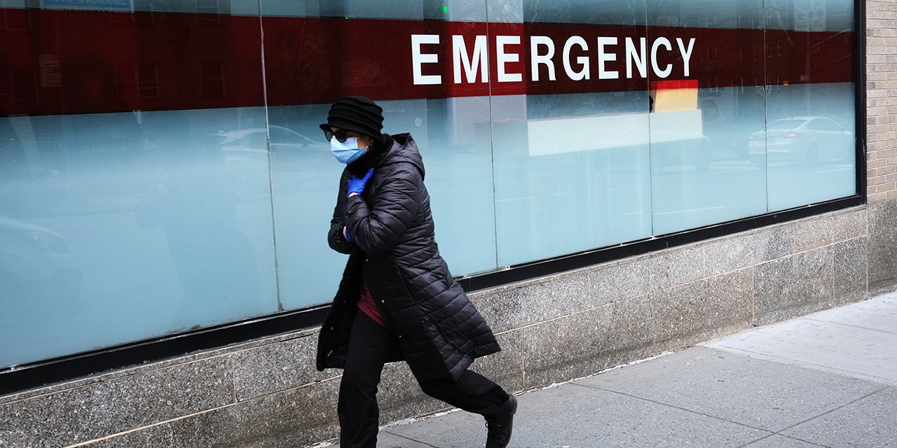 A woman walks by the emergency entrance to Mount Sinai Hospital in New York City on March 31. (Spencer Platt/Getty Images)