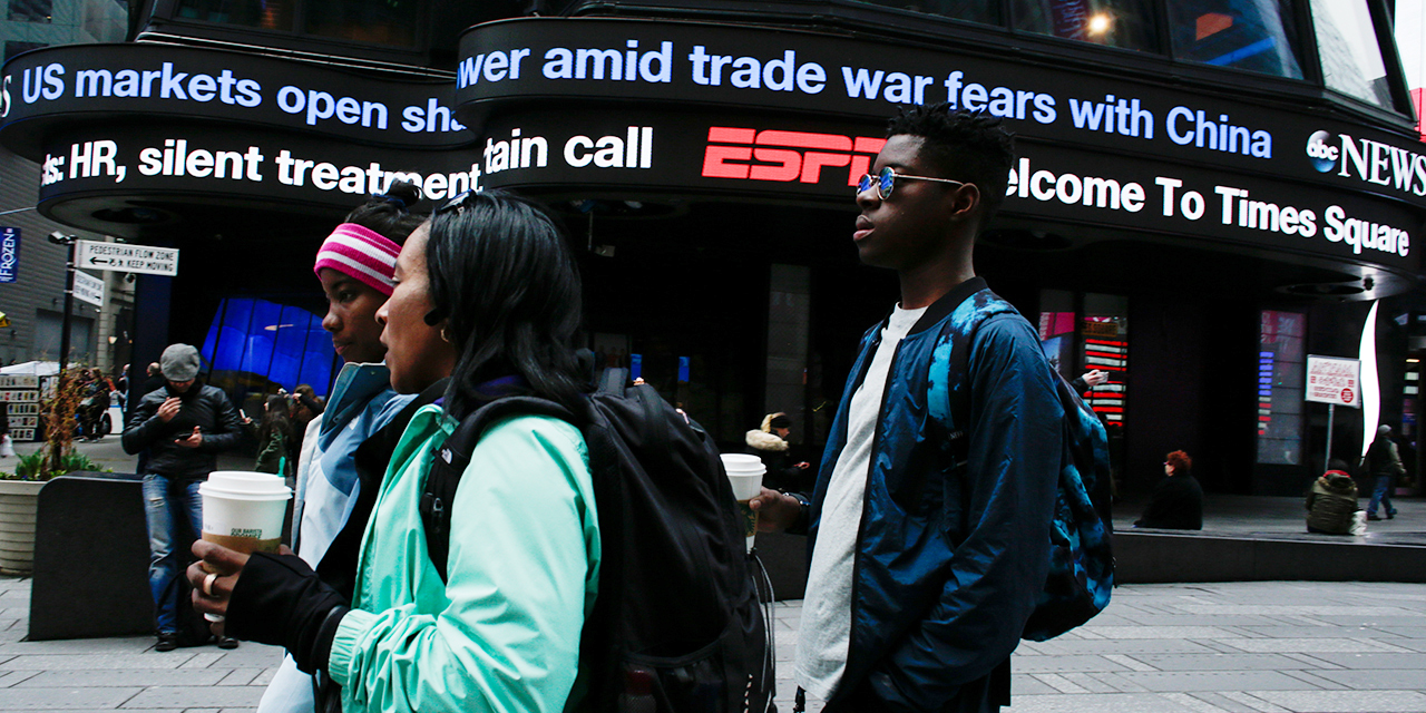 Headlines scrolling in New York City's Times Square in April 2018, shortly after the Trump administration imposed sanctions on billions of dollars in Chinese goods. (Kena Betancur/VIEWpress/Corbis via Getty Images)