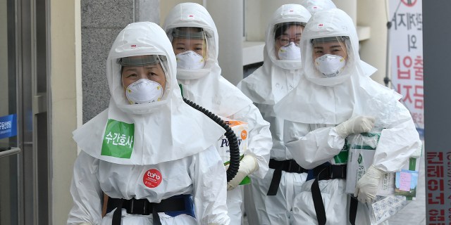 Nurses in protective gear arrive to care for patients infected with the coronavirus at Keimyung University Daegu Dongsan Hospital in Daegu, South Korea, on April 29. (Jung Yeon-je/AFP via Getty Images)
