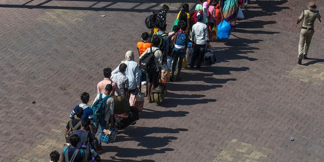 People in Mumbai wait to return by train to their respective villages across India at Lokmanya Tilak Terminus on May 30, 2020. (Pratik Chorge/Hindustan Times via Getty Images)