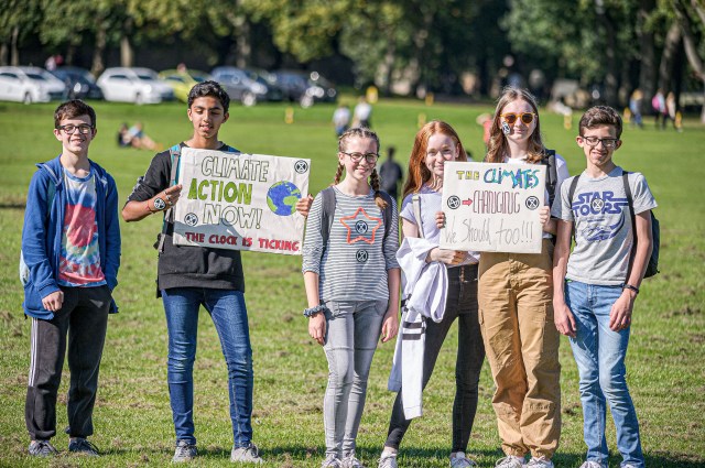 Friends hold signs calling for action against climate change during a demonstration march in Edinburgh in September 2019. (Stewart Kirby/SOPA Images/LightRocket via Getty Images)