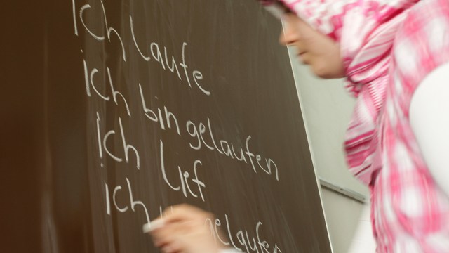 A student in Berlin conjugates a verb for class. (Scherhaufer/ullstein bild via Getty Images)