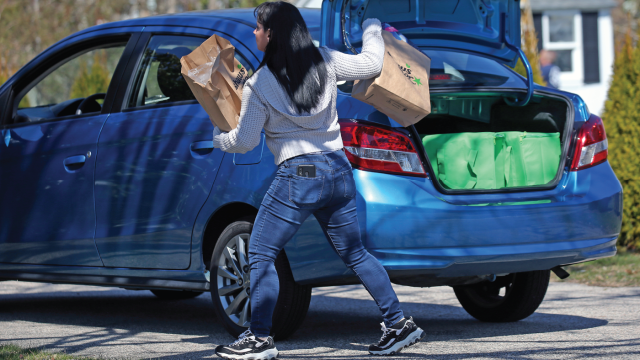 Photograph shows an Instacart shopper making a delivery to a customer's home in Falmouth, Massachusetts, in 2020 during the COVID-19 pandemic.