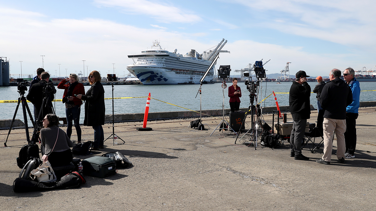 Journalists set up at the Port of Oakland, California, on March 10, across from the cruise ship Grand Princess. Passengers had begun to disembark after 21 people on board tested positive for COVID-19. (Justin Sullivan/Getty Images)