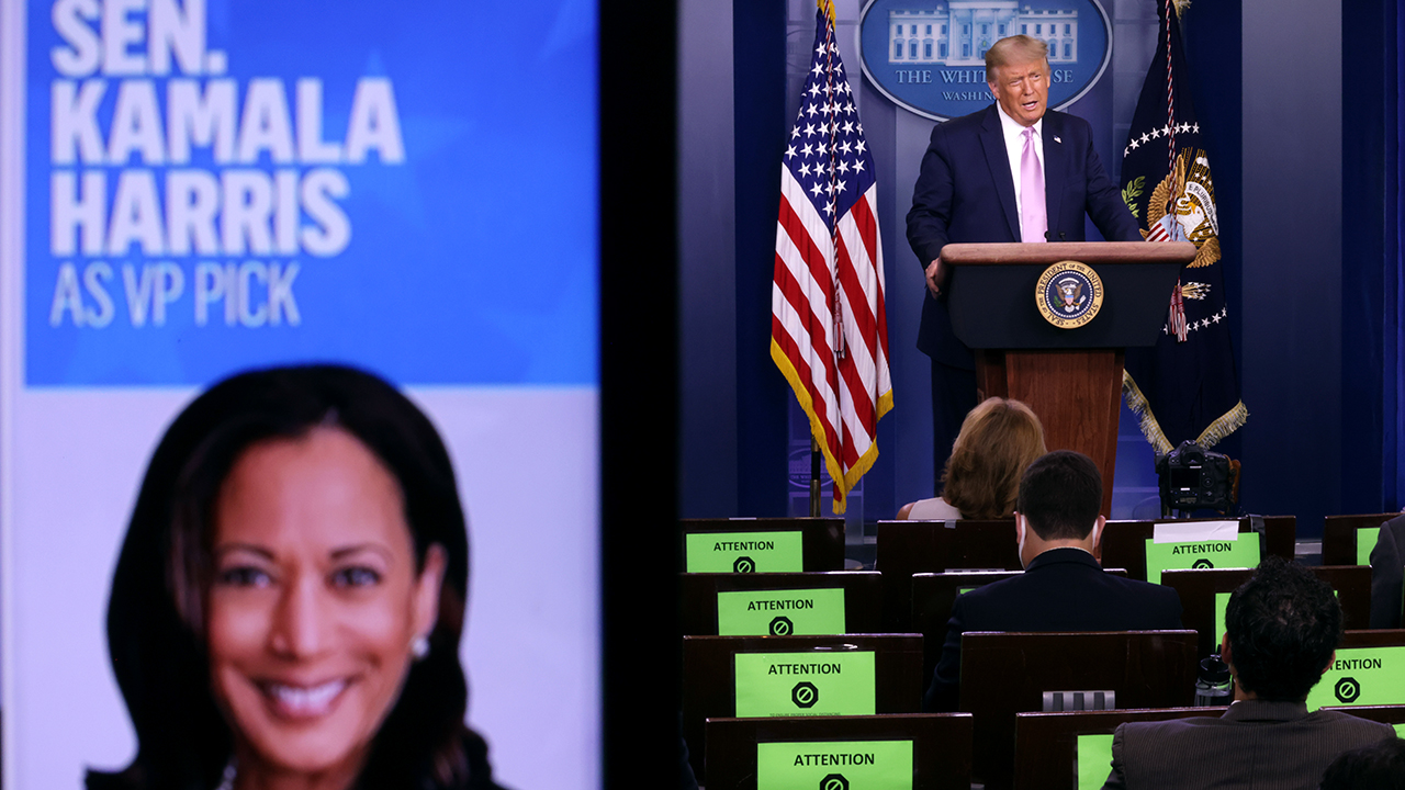 President Donald Trump speaks as a picture of Democratic vice presidential nominee Kamala Harris is seen on a screen during a news conference in the White House. (Alex Wong/Getty Images)