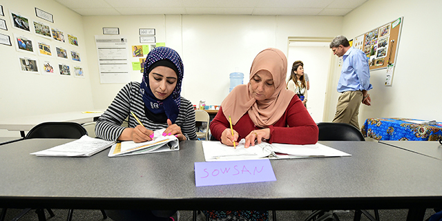 Syrian refugees take notes during their Vocational ESL class at the International Rescue Committee center in San Diego on August 31, 2016. Seated from left to right are: Rawa Hawara and Sousan Alziat. The United States has taken in10,000 Syrian refugees in 2016 as part of a resettlement program that has emerged as a hot-button issue in the US presidential campaign. / AFP / Frederic J. BROWN (Photo credit should read FREDERIC J. BROWN/AFP/Getty Images)