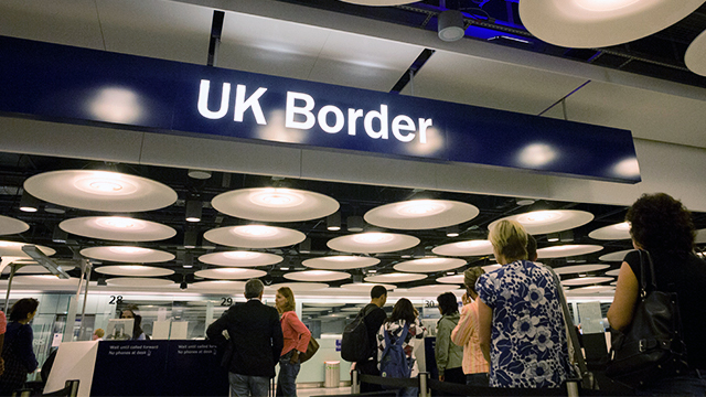 Airline passengers wait to enter the UK Border Agency's passport control area at Heathrow Airport. (Richard Baker/In Pictures via Getty Images)