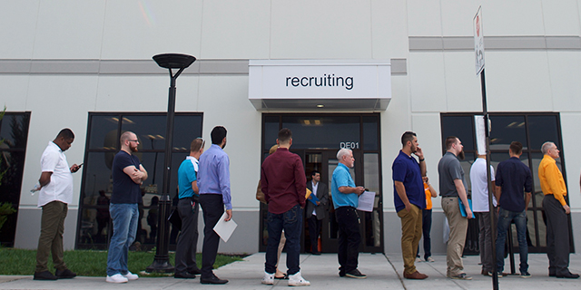 Job seekers wait in line during a jobs fair at the Amazon Fulfillment Center in Robbinsville, New Jersey, on Aug. 2. (Mark Makela/Getty Images)