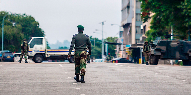 Zimbabwean soldiers stand at an intersection as they regulate traffic in Harare on Nov. 15, 2017. Generals denied that the military had staged a coup but vowed on state television to target "criminals" close to President Robert Mugabe. (AFP/Getty Images)