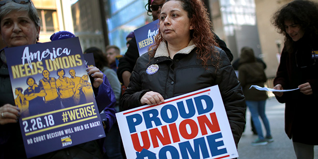 Union members hold a rally at Richard J. Daley Center in Chicago on Feb. 26. (Scott Olson/Getty Images)