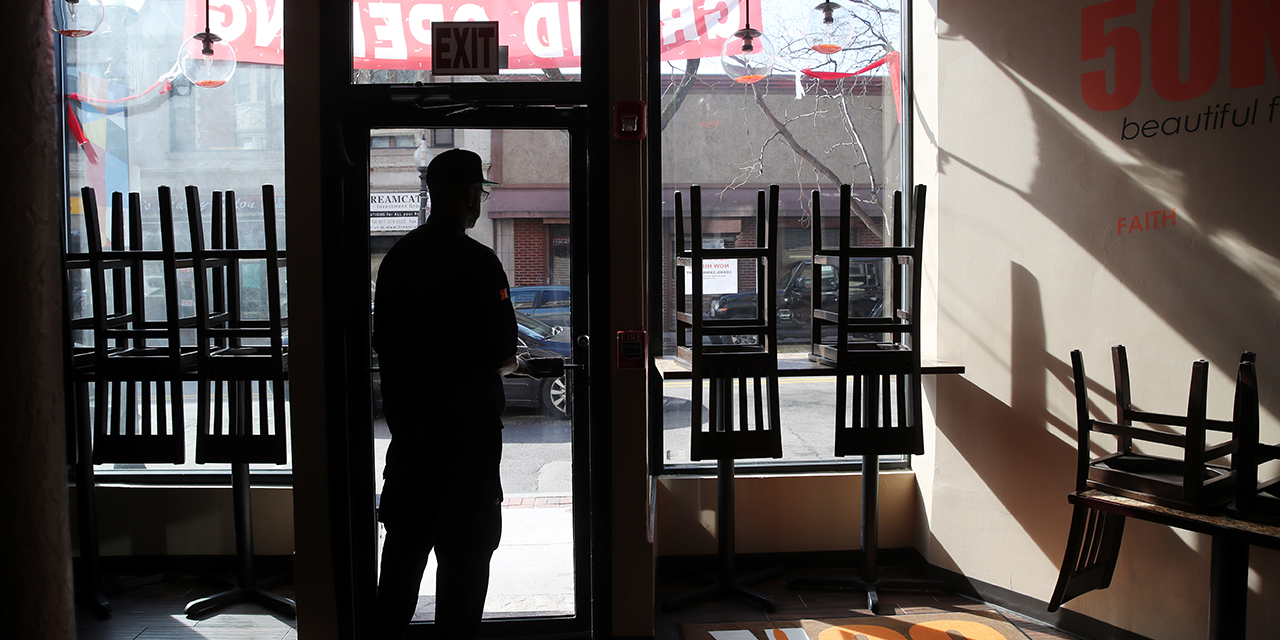 A Boston restaurant owner surveys his empty establishment. (Craig F. Walker/The Boston Globe via Getty Images)