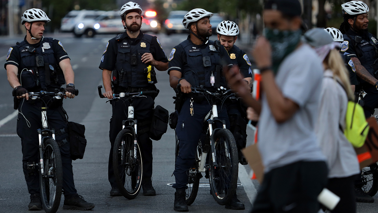 Metropolitan police officers in Washington, D.C., watched protesters leave a rally on June 2, 2020, in Washington, D.C., after the death of George Floyd, a black man who died in police custody in Minneapolis on May 25. (Alex Wong/Getty Images)