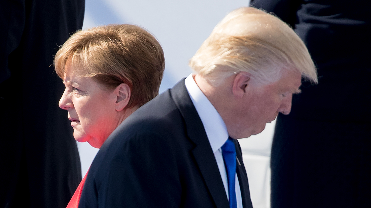 Chancellor Angela Merkel of Germany and President Donald Trump walked by each other in 2017. (Kay Nietfeld/picture alliance via Getty Images)