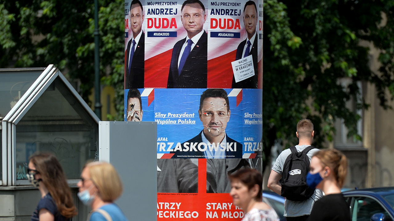 Election posters of presidential incumbent Andrzej Duda and challenger Rafal Trzaskowski on a street in Krakow, Poland, on July 2. A runoff between the two is planned for July 12. (Artur Widak/NurPhoto via Getty Images)