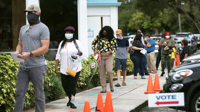 Voters wait in line, socially distanced from each other, to cast early ballots on Oct. 19, 2020, in Miami, Florida. (Joe Raedle/Getty Images)