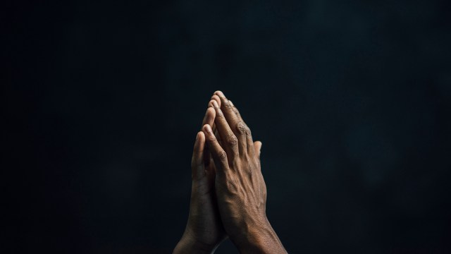 A pair of hands raised in prayer. (westend61/Getty Images)