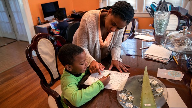 Geri Andre-Major helps her son Max, 5, with his schoolwork on March 26, 2020, in Mount Vernon, New York. (John Moore/Getty Images)