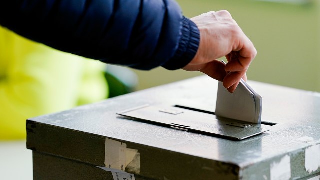 A voter turns in her ballot at a polling station in Mannheim, Germany, on March 14. About two-thirds of adults in Germany say it is important to make voting compulsory for all citizens. (Uwe Anspach/picture alliance via Getty Images)