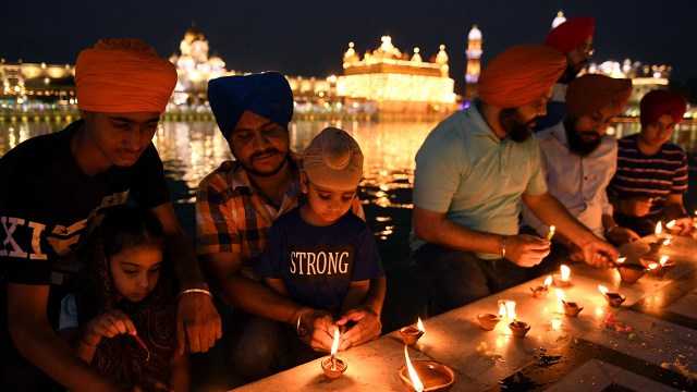 Sikh devotees light candles at the Golden Temple in Amritsar, India, on June 25, 2021. (Narinder Nanu/AFP via Getty Images)