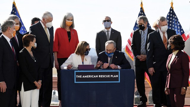 House Speaker Nancy Pelosi and Senate Majority Leader Chuck Schumer sign the American Rescue Plan Act outside the U.S. Capitol after the House voted to pass the $1.9 trillion COVID-19 relief plan on March 10, 2021. 
