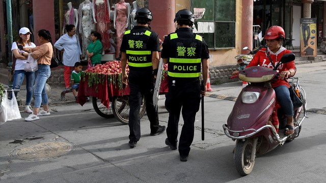 Police officers patrol Kashgar, China, in the western Xinjiang region on June 4, 2019, following the destruction of mosques at the end of Ramadan.