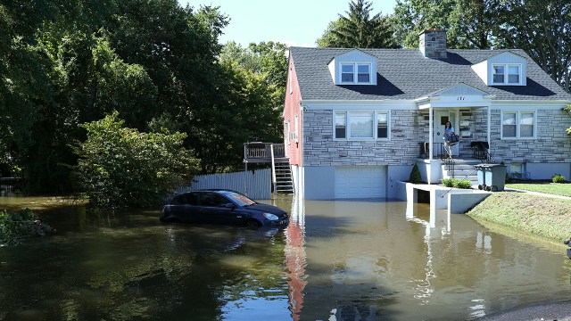 A car sits in a flooded driveway on Sept. 2, 2021, in Mamaroneck, New York, after Hurricane Ida passed through the region.