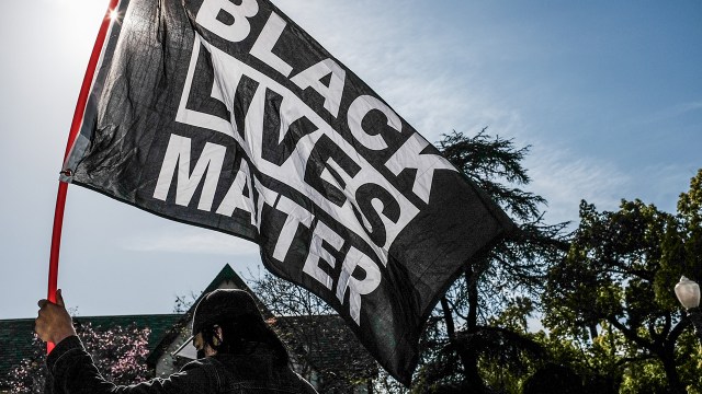 A protester holds a Black Lives Matter flag at a demonstration in Los Angeles on April 20, 2021, hours after former Minneapolis police officer Derek Chauvin was found guilty in the murder of George Floyd.