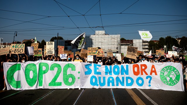 Climate activists hold a banner reading “COP26: If not now, when?” in Turin, Italy, on Sept. 24, 2021, during a worldwide climate strike against governmental inaction toward climate breakdown and environmental pollution.