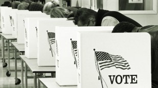 Photo showing voters cast their ballots on Election Day November 04, 2008, at Centreville High School in Clifton, Virginia. Americans crowded polling stations Tuesday to vote in their historic election, with front-running Democrat Barack Obama seeking to become the first black US president and Republican rival John McCain battling for a comeback. AFP Photo/Paul J. Richards (Photo credit should read PAUL J. RICHARDS/AFP via Getty Images)