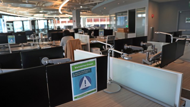 A largely empty office area in Boston in April 2021. Employees returned to work in a hybrid model soon after. (David L. Ryan/The Boston Globe via Getty Images)